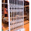Modern steel collapsible burglar proof security gate with a durable powder-coated finish, custom manufactured by Trust and Smart Metals.