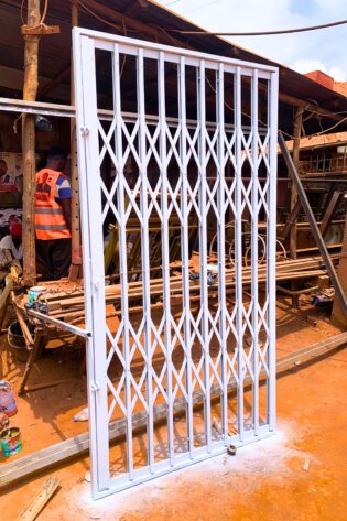 Modern steel collapsible burglar proof security gate with a durable powder-coated finish, custom manufactured by Trust and Smart Metals.