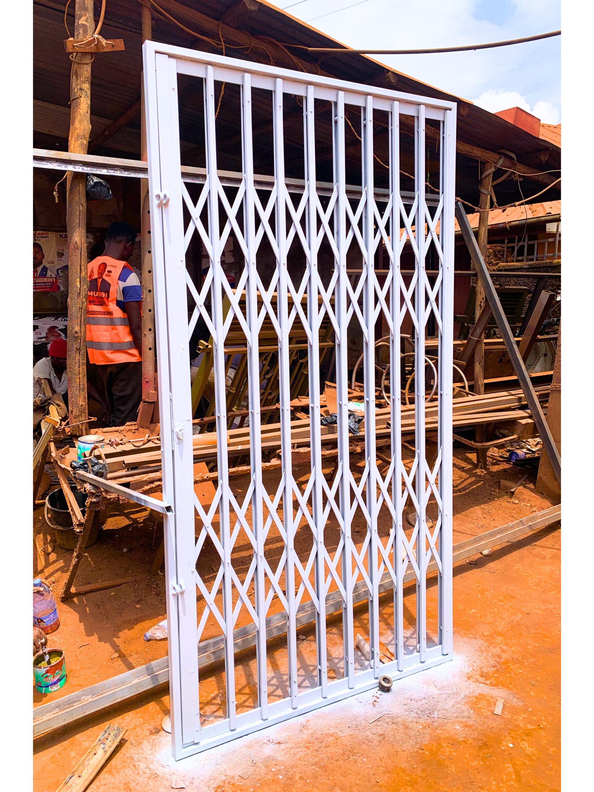 Modern steel collapsible burglar proof security gate with a durable powder-coated finish, custom manufactured by Trust and Smart Metals.