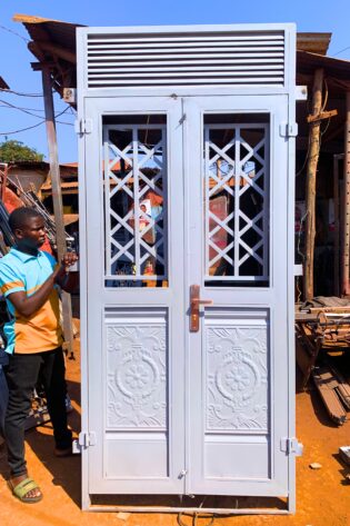 Modern steel front door with a powder-coated finish, custom manufactured by Trust and Smart Metals for residential and commercial buildings.