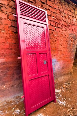 Modern steel plate door with a heavy-duty powder-coated finish, custom manufactured by Trust and Smart Metals.
