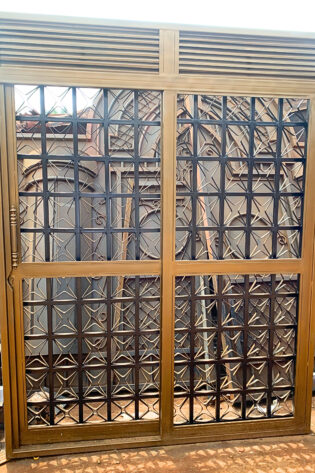 Modern steel sliding single door with powder-coated finish for residential and commercial buildings by Trust and Smart Metals.
