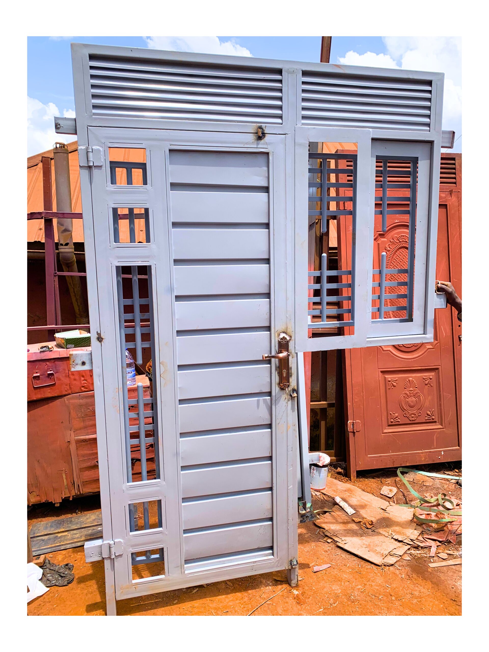 Modern steel combined door with window, featuring a durable powder-coated finish and custom design by Trust and Smart Metals.