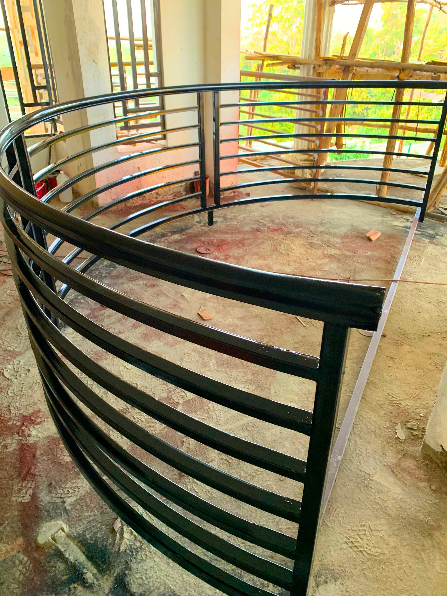 Customized curved steel balcony railing with a durable powder-coated finish, custom manufactured by Trust and Smart Metals.