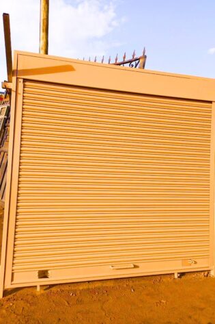 Modern steel roller shutter door with a durable powder-coated finish, custom manufactured by Trust and Smart Metals for residential and commercial buildings.
