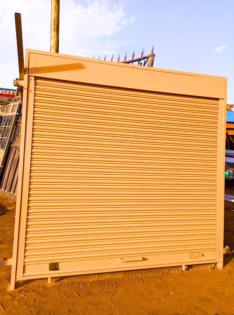 Modern steel roller shutter door with a durable powder-coated finish, custom manufactured by Trust and Smart Metals for residential and commercial buildings.