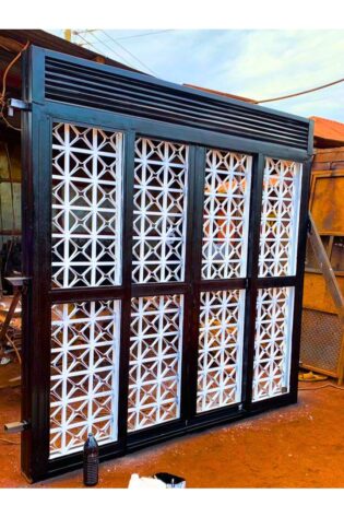 Modern steel double sliding door with a durable powder-coated finish, custom manufactured by Trust and Smart Metals for residential and commercial buildings.