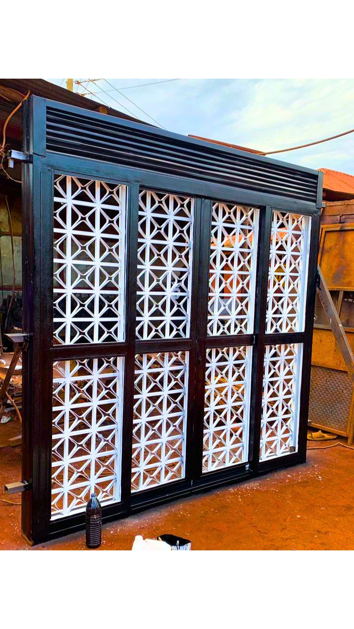 Modern steel double sliding door with a durable powder-coated finish, custom manufactured by Trust and Smart Metals for residential and commercial buildings.
