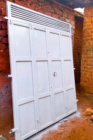 Modern steel bi-fold door with a durable powder-coated finish, custom manufactured by Trust and Smart Metals for residential and commercial buildings.