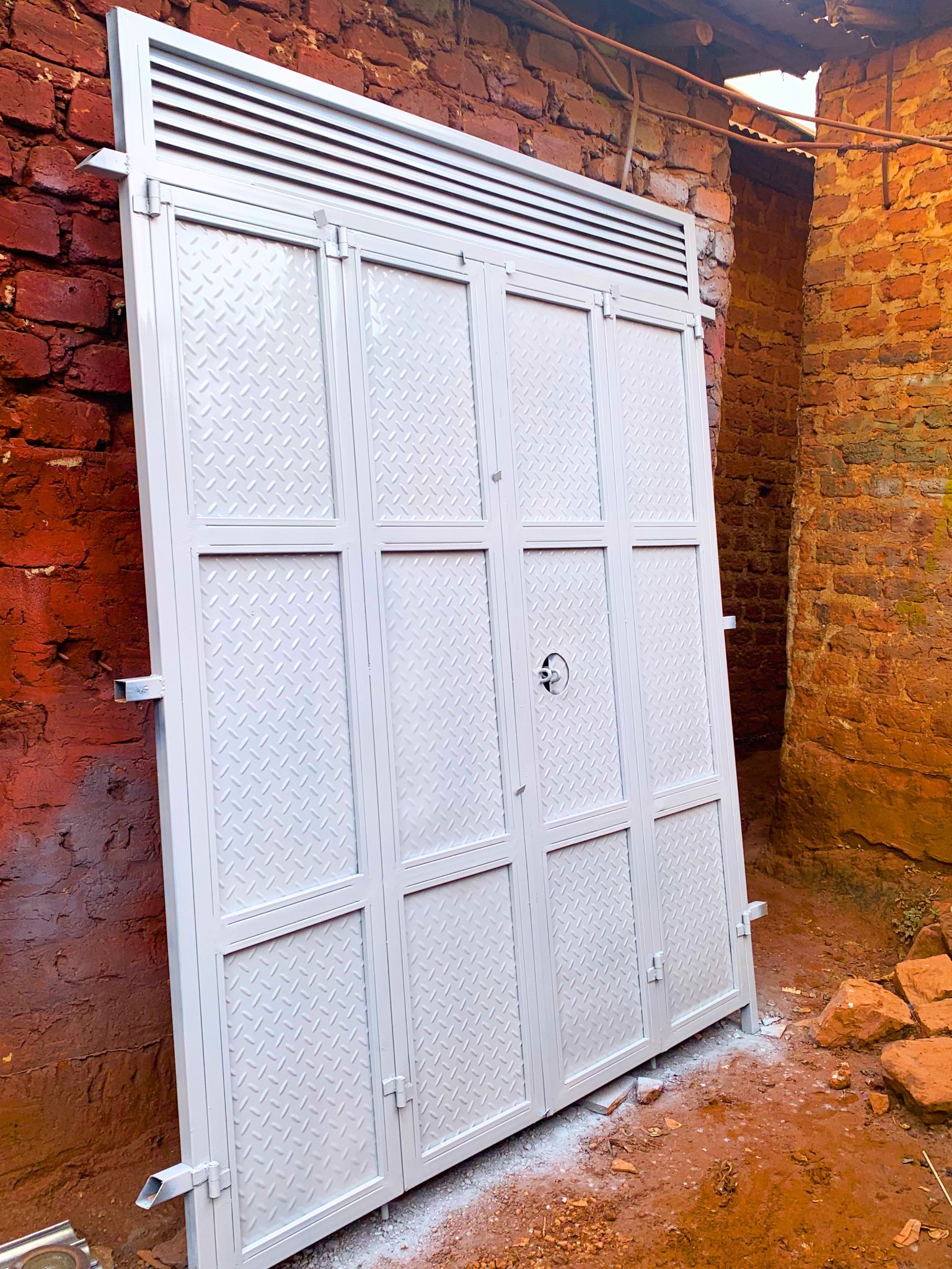 Modern steel bi-fold door with a durable powder-coated finish, custom manufactured by Trust and Smart Metals for residential and commercial buildings.
