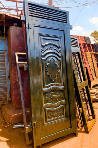 Modern steel design plate door with decorative steel patterns and a durable powder-coated finish, custom manufactured by Trust and Smart Metals.