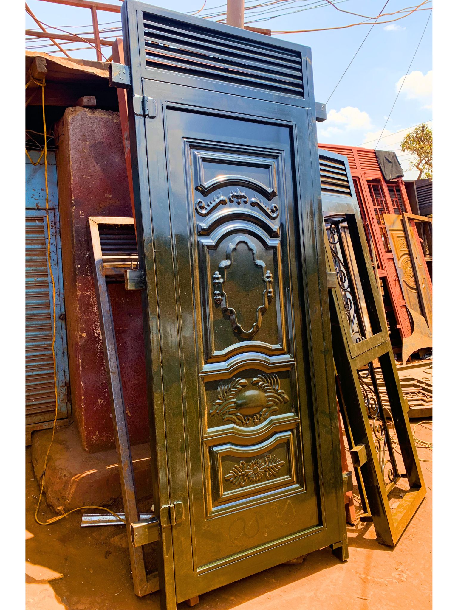 Modern steel design plate door with decorative steel patterns and a durable powder-coated finish, custom manufactured by Trust and Smart Metals.